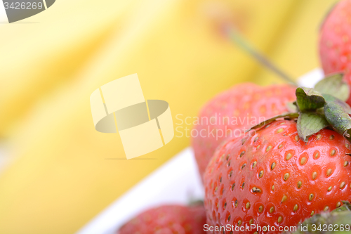 Image of composition of banana and strawberry close up