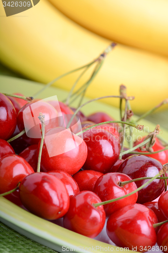 Image of Close up of a fresh pile of fruit consisting of cherries and bananas