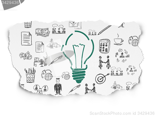 Image of Finance concept: Light Bulb on Torn Paper background