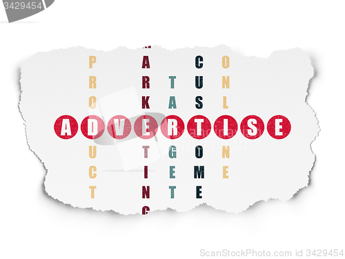 Image of Advertising concept: word Advertise in solving Crossword Puzzle