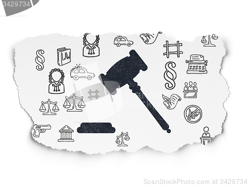 Image of Law concept: Gavel on Torn Paper background