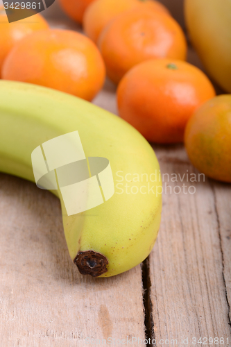 Image of Fresh colorful fruits composition mandarin, bananas and orange