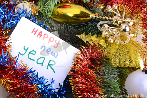 Image of Christmas greeting card with a branch of tree and Christmas decorations, watercolor hand drawn congratulation happy new year words
