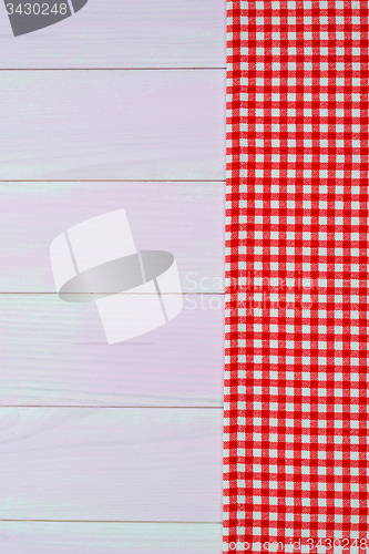 Image of White and red towel over wooden table