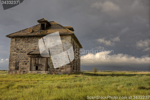 Image of Storm Clouds Prairie Sky stone house