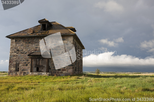 Image of Storm Clouds Prairie Sky stone house