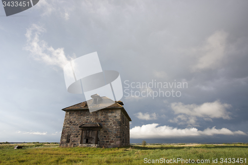 Image of Storm Clouds Prairie Sky stone house