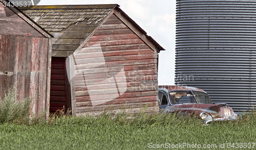 Image of Wooden Granary and old car