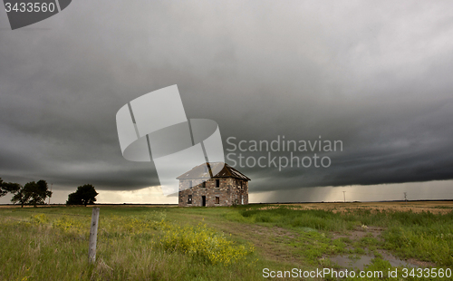 Image of Storm Clouds Prairie Sky stone house