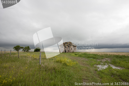 Image of Storm Clouds Prairie Sky stone house