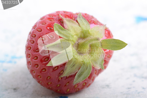 Image of big fresh strawberry with green leave, close up