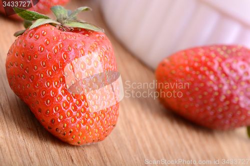 Image of Strawberry set on wooden plate close up