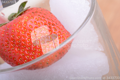 Image of strawberry frozen in ice cube, health food concept