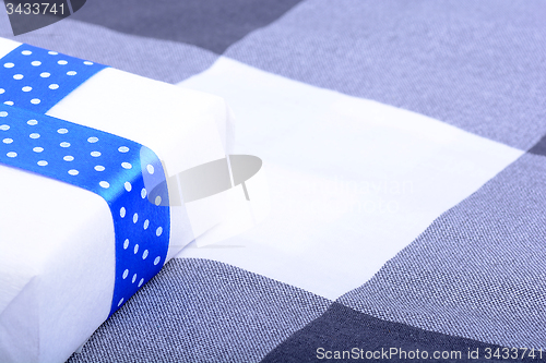 Image of White gift box with blue ribbon