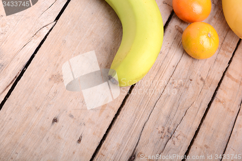 Image of Fresh colorful fruits composition mandarin, bananas and orange