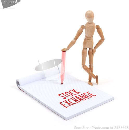 Image of Wooden mannequin writing - Stock exchange