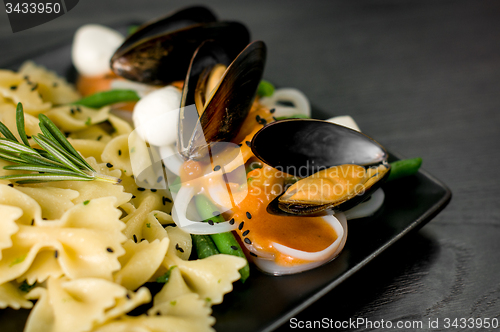 Image of Delicious portion of Farfalle with seafood and mozzarella