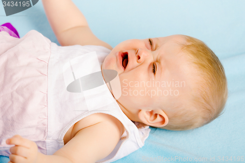 Image of Crying baby lying on plaid