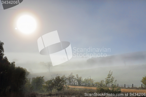 Image of Winter sun in foggy landscape