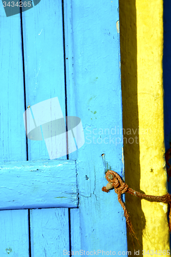 Image of yellow rope  in africa the old wood  facade home and safe padloc