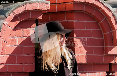 Image of Blonde in black in old town
