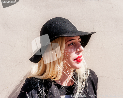 Image of Blonde in black in old town