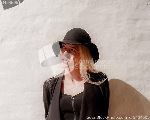Image of Blonde in black in old town