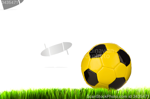 Image of Yellow football on grass field