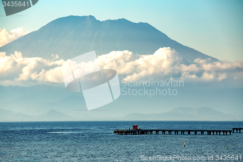 Image of view on Bali from ocean, vulcano in clouds