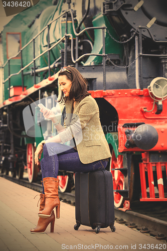 Image of pretty middle-aged woman with a mobile phone