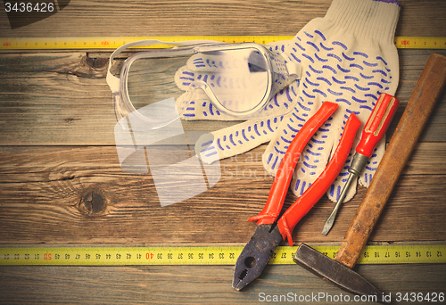 Image of set of the old locksmith tools, safety glasses and work gloves