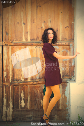 Image of beautiful woman in a burgundy dress