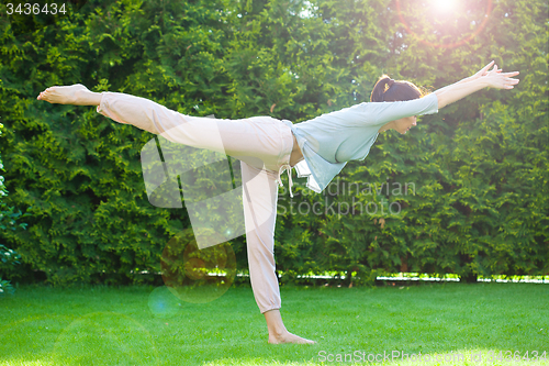 Image of beautiful adult woman doing yoga