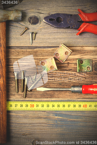 Image of pliers, screwdriver, screws, hammer, angles and roulette