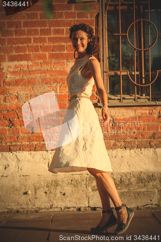 Image of beautiful middle-aged woman in a white dress