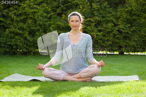 Image of beautiful adult woman doing yoga