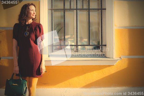 Image of beautiful woman in a maroon dress
