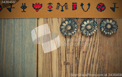 Image of vintage brown band with embroidered ornaments and old buttons