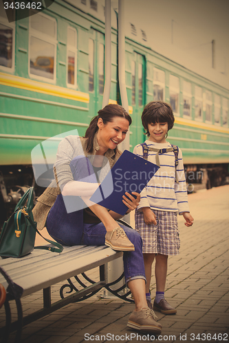 Image of mother and son waiting for a train