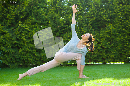 Image of beautiful adult woman doing yoga