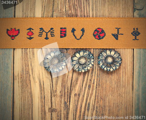 Image of vintage tape with embroidered ornaments and old buttons