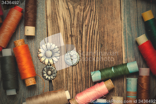 Image of vintage tools of thread and old buttons