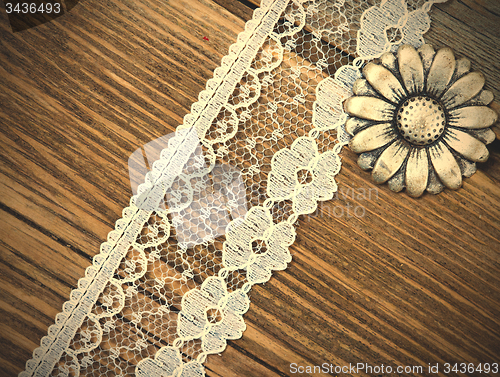 Image of vintage button and lace tape