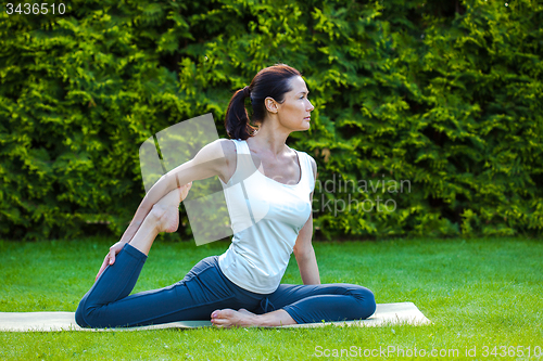 Image of pretty adult lady doing yoga