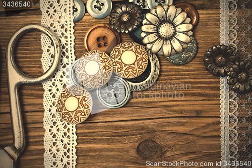 Image of vintage buttons, lace, and a tailor scissors