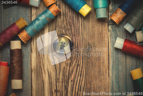 Image of vintage button and spools of thread