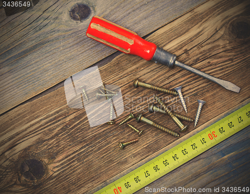 Image of group of screw with a screwdriver