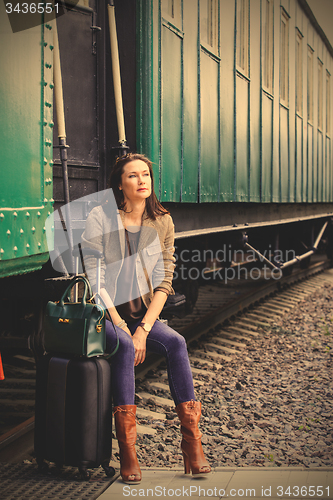 Image of beautiful middle-aged woman traveling in a retro style