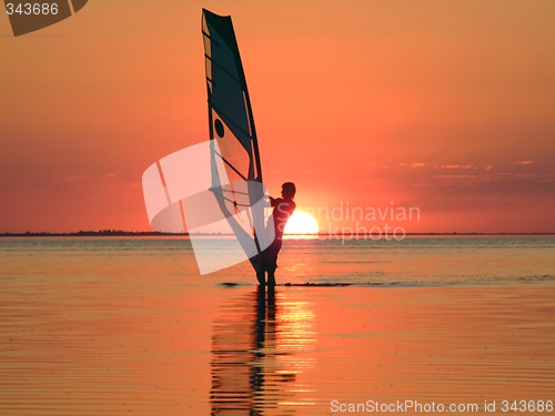 Image of Silhouette of a windsurfer on waves of a gulf on a sunset 4
