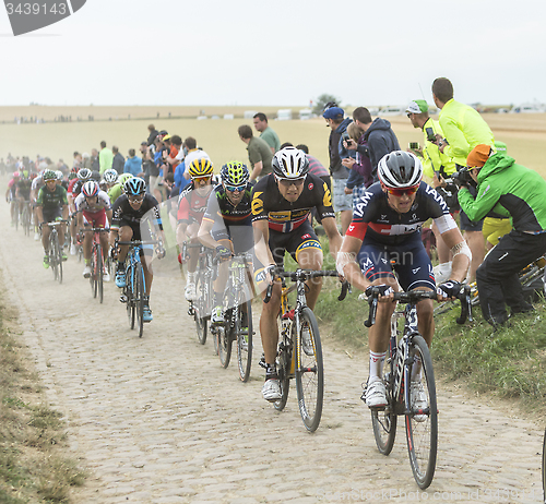 Image of The Peloton on a Cobblestones Road - Tour de France 2015